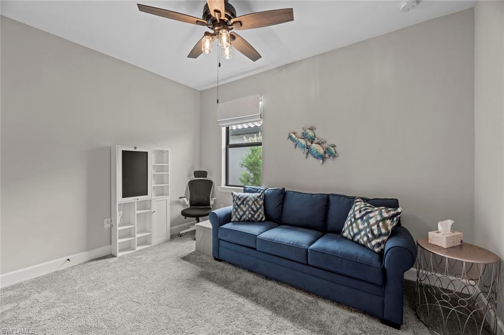 19648 Beechcrest Place Estero, FL 33928 - Photo 19 of 34 a living room with furniture and a flat screen tv