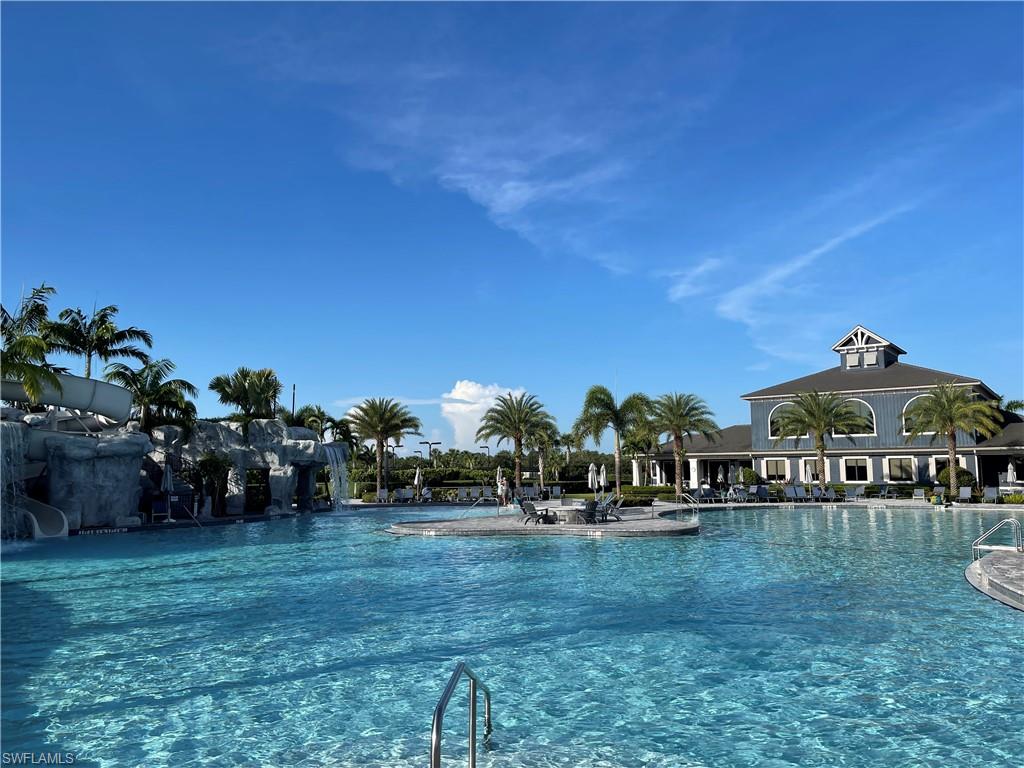19648 Beechcrest Place Estero, FL 33928 - Photo 29 of 34 a view of a yard with table and chairs a barbeque