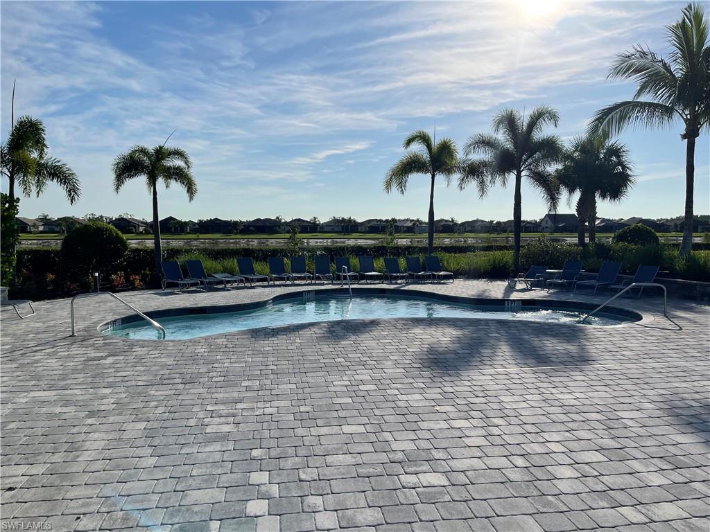 19648 Beechcrest Place Estero, FL 33928 - Photo 31 of 34 a view of swimming pool with a table and chairs