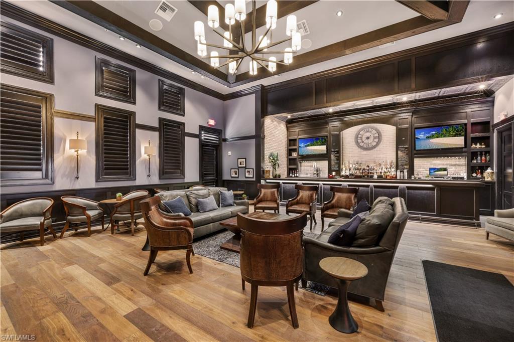 19648 Beechcrest Place Estero, FL 33928 - Photo 34 of 34 a living room with furniture a chandelier and a rug