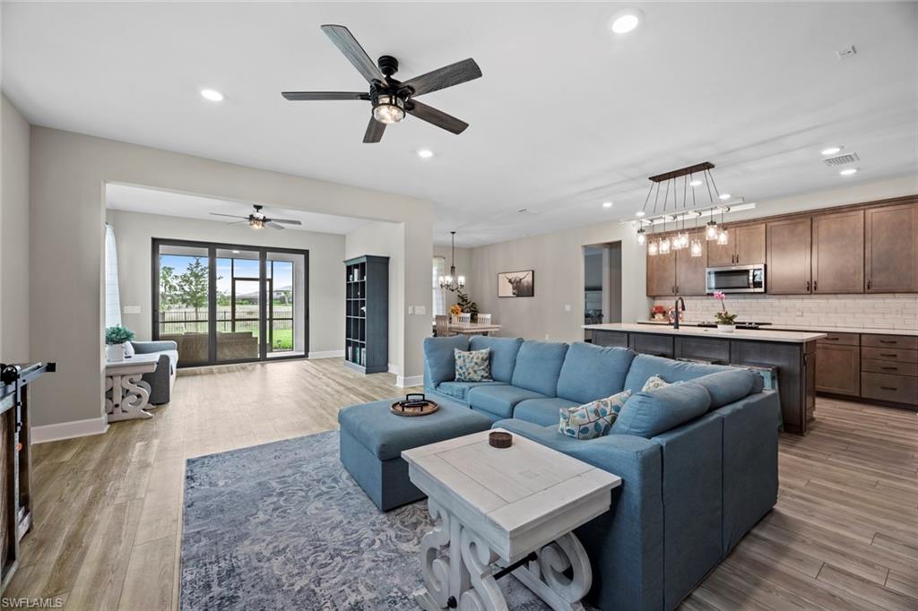 19648 Beechcrest Place Estero, FL 33928 - Photo 6 of 34 a living room with furniture and kitchen view