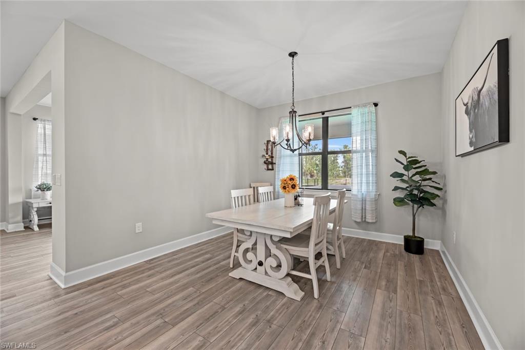 19648 Beechcrest Place Estero, FL 33928 - Photo 7 of 34 a view of a dining room with furniture window and wooden floor
