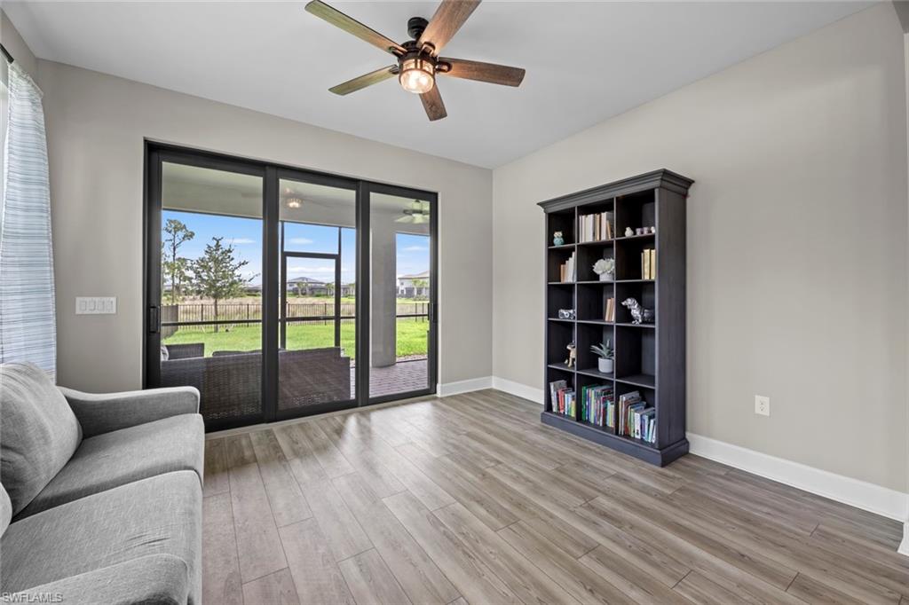 19648 Beechcrest Place Estero, FL 33928 - Photo 9 of 34 a living room with furniture and a large window with wooden floor