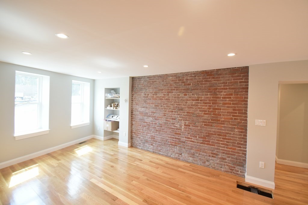 173 Prospect Street, Unit 1 Waltham, MA 02453 - Photo 4 of 8 a view of an empty room with a window