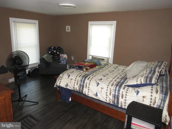 a bedroom with a bed and dresser