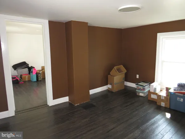 a view of a livingroom with wooden floor and a window
