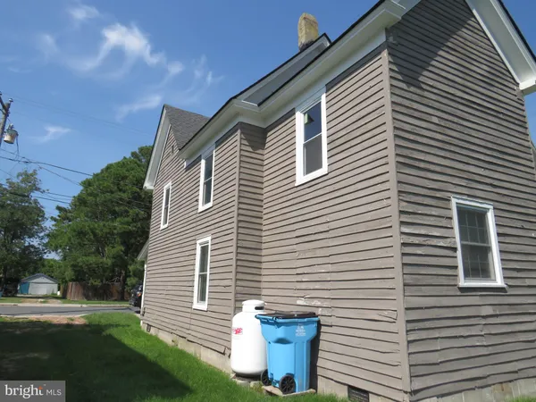 a view of a house with a yard and a garage