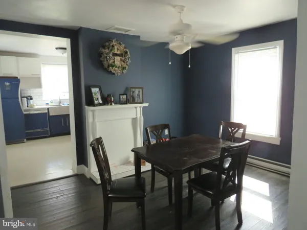 a view of a dining room with furniture wooden floor and a chandelier