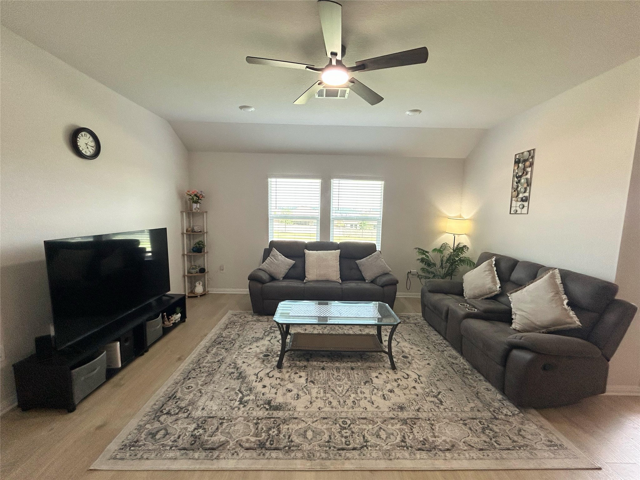 2412 Lightning View Leander, TX 78641 - Photo 6 of 24 A contemporary living area presents a spacious layout and light-toned flooring under recessed lighting and a ceiling fan.