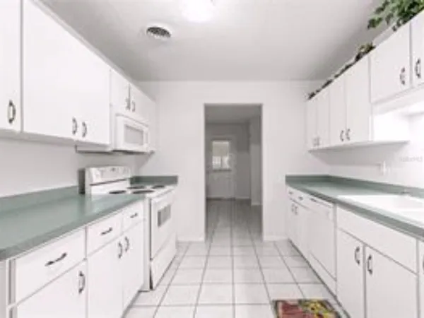 a kitchen with cabinets and appliances
