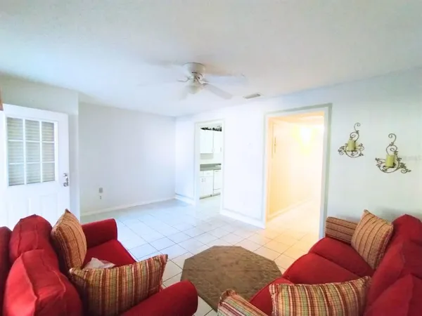 a dining room with furniture and a floor to ceiling window