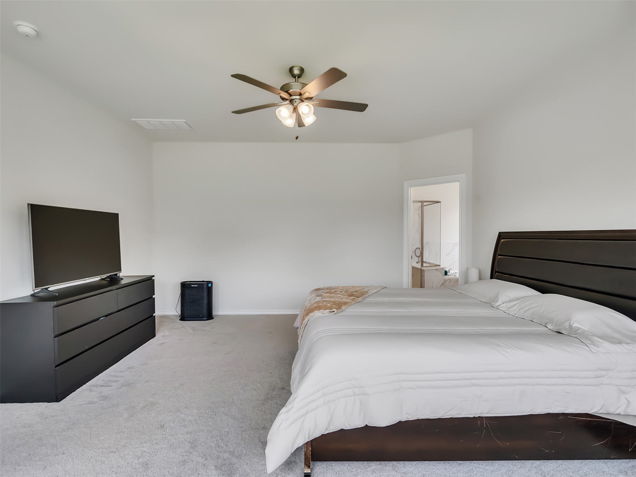 27997 Lone Hollow Lane Spring, TX 77386 - Photo 39 of 45 a bedroom with a bed and a chandelier