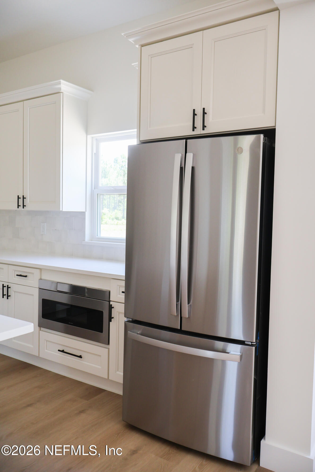 261121 Rowe Road Hilliard, FL 32046 - Photo 16 of 33 a view of kitchen with stainless steel appliances granite countertop cabinets and a window