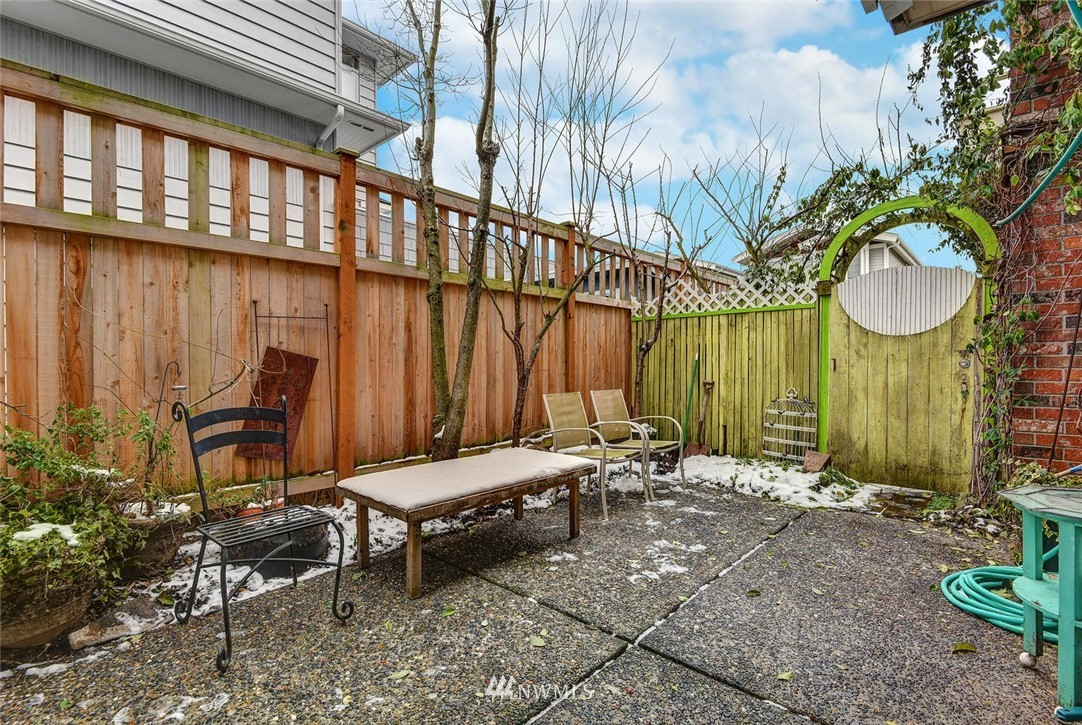 623 Main Street, Unit 3 Edmonds, WA 98020 - Photo 10 of 10 a backyard of a house with table and chairs