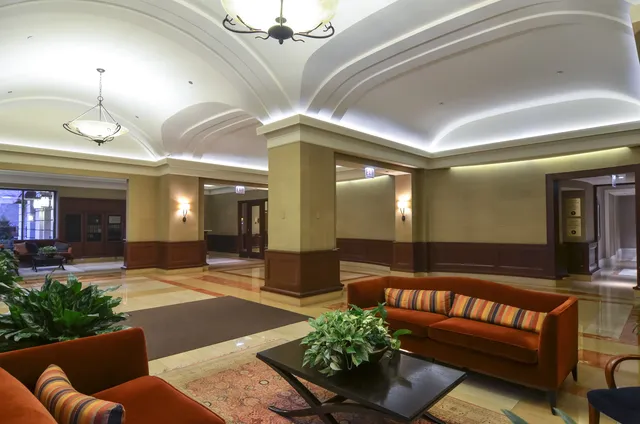 a lobby with furniture and chandelier