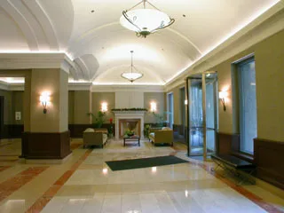 a lobby with a chandelier furniture and a chandelier