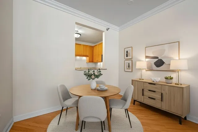 a view of a dining room with furniture and wooden floor