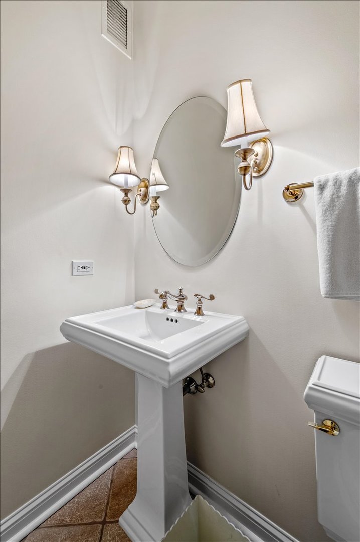 25 East Superior Street, Unit 605 Chicago, IL 60611 - Photo 9 of 24 a bathroom with a sink a toilet and mirror