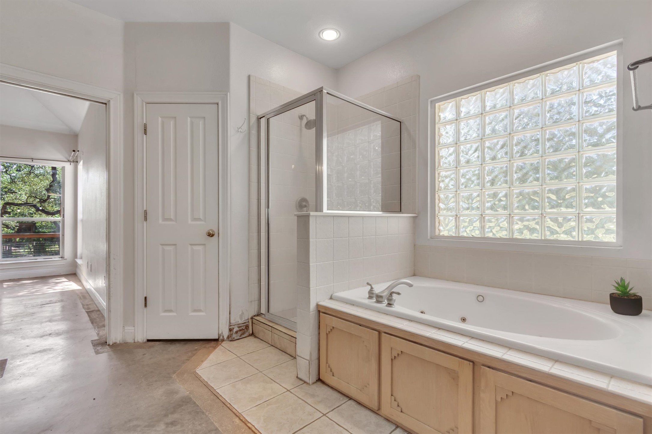 1120 Meadow Ridge Drive Austin, TX 78737 - Photo 20 of 40 Indulge in a relaxing soak in this bathroom's spacious tub and enjoy the outdoor views.