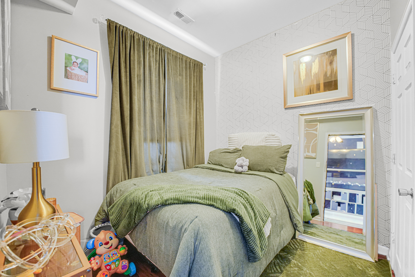 7222 South Rhodes Avenue Chicago, IL 60619 - Photo 14 of 22 a bed sitting in a bedroom next to a lamp