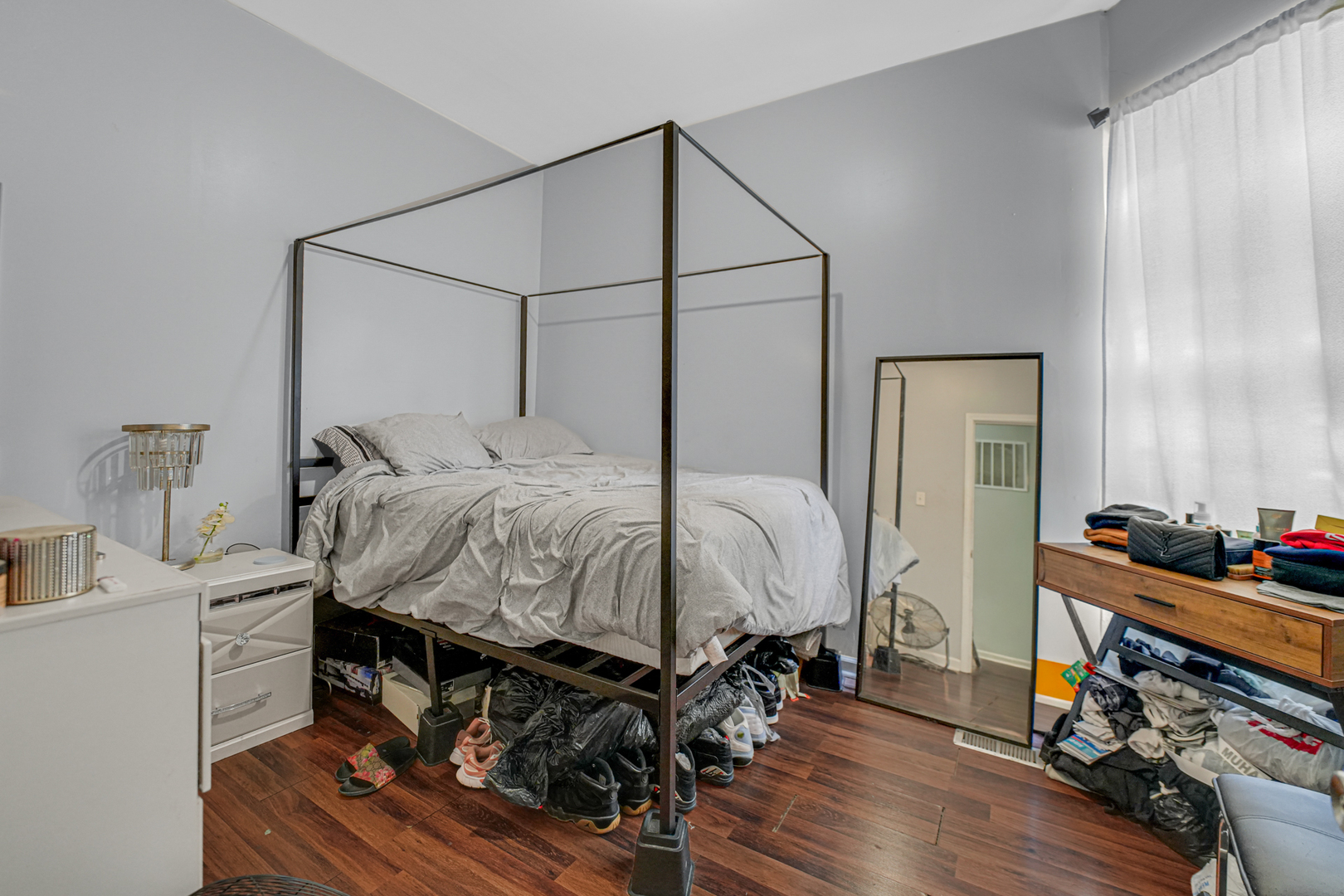 7222 South Rhodes Avenue Chicago, IL 60619 - Photo 17 of 22 a bedroom with a bed and wooden floor