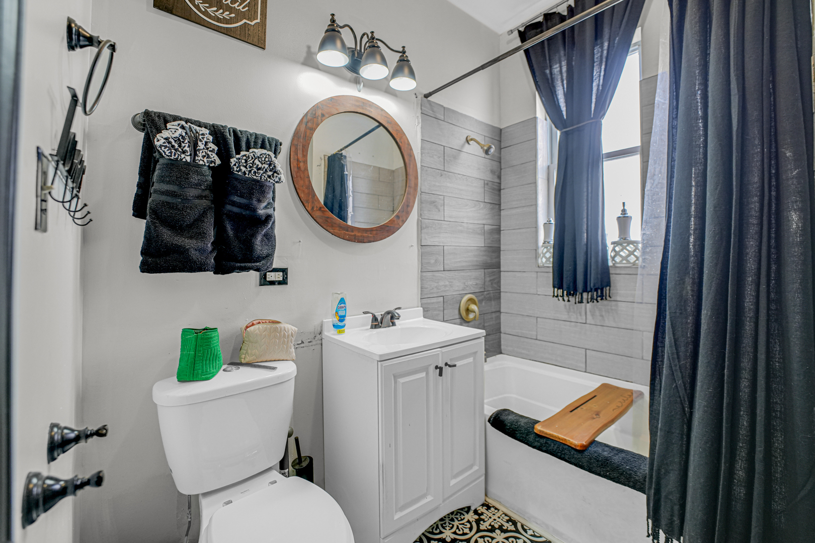 7222 South Rhodes Avenue Chicago, IL 60619 - Photo 18 of 22 a bathroom with a toilet a sink and a mirror