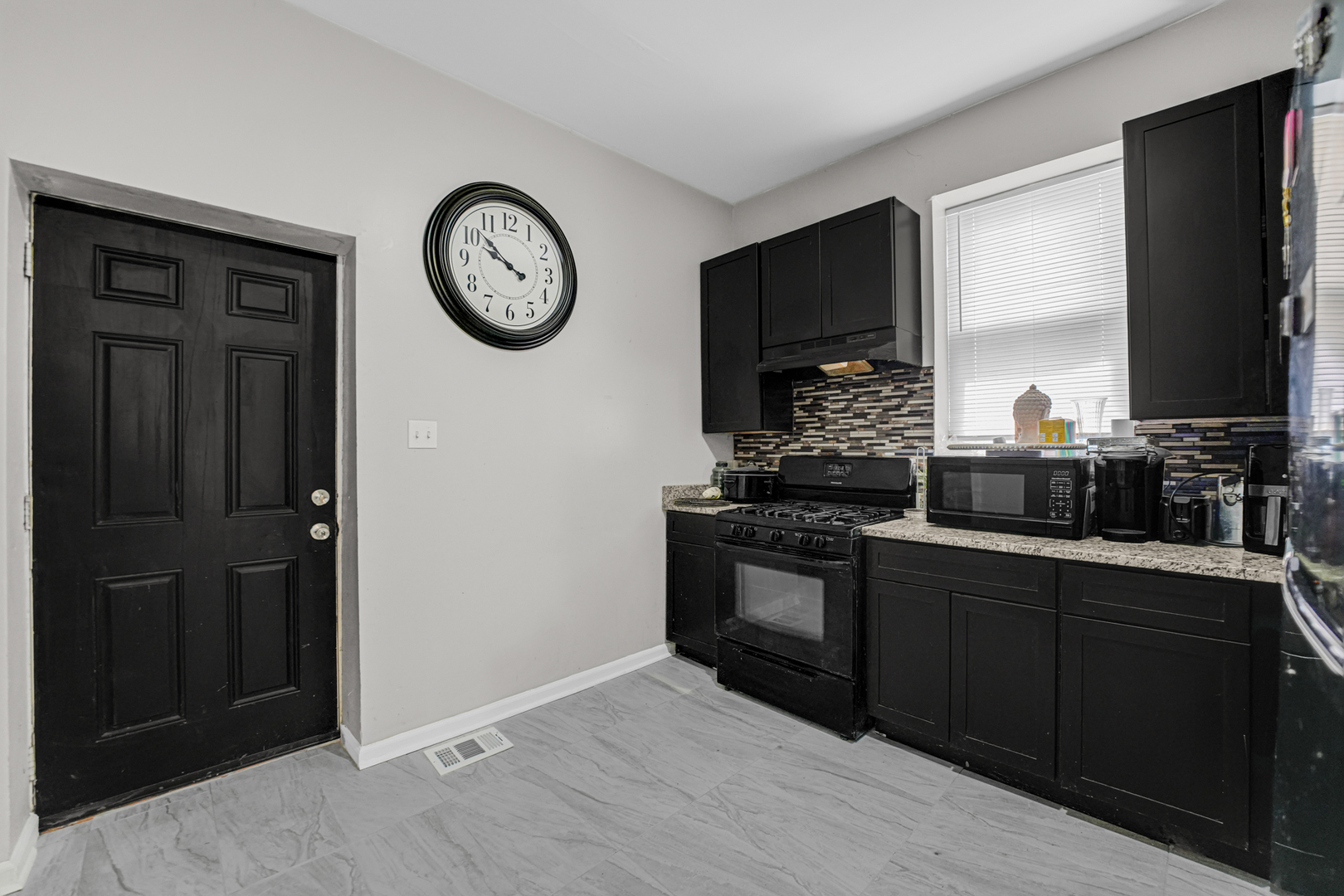 7222 South Rhodes Avenue Chicago, IL 60619 - Photo 8 of 22 a kitchen with a refrigerator and a stove top oven