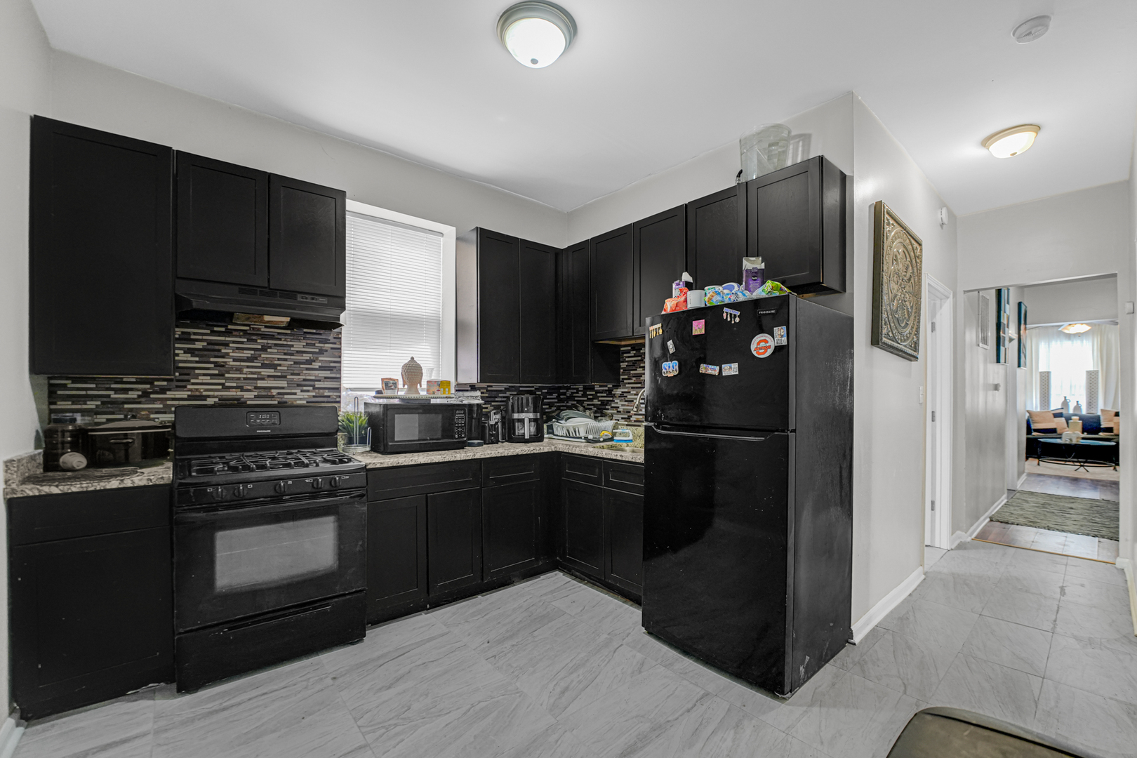 7222 South Rhodes Avenue Chicago, IL 60619 - Photo 9 of 22 a kitchen with a refrigerator and a sink