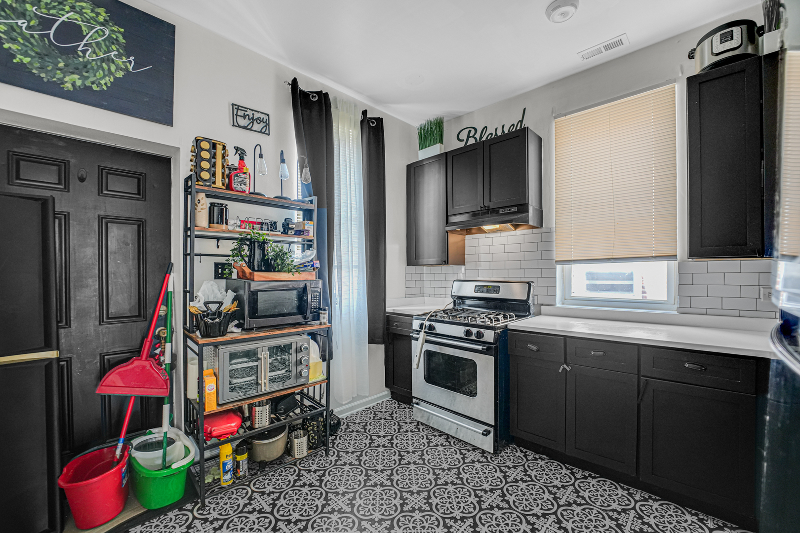 7222 South Rhodes Avenue Chicago, IL 60619 - Photo 10 of 22 a kitchen that has a lot of cabinets a washer and dryer