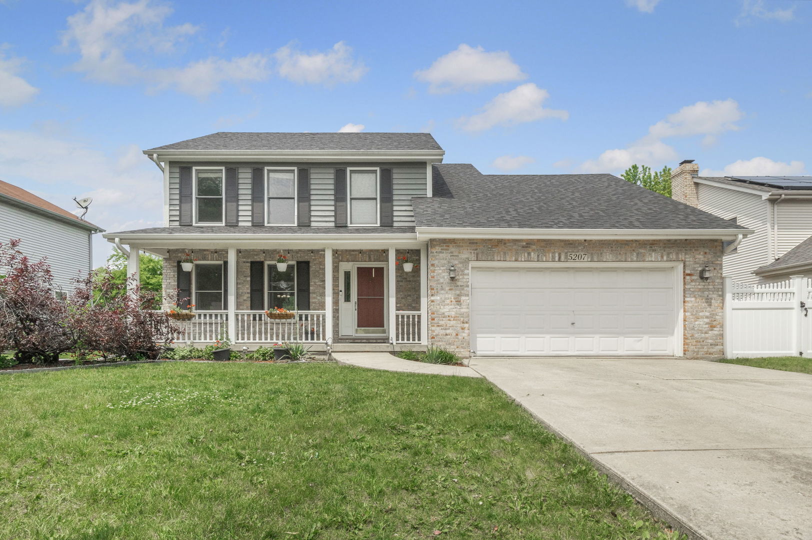 5207 Sunmeadow Drive Plainfield, IL 60586 - Photo 1 of 32 a front view of a house with a yard and garage