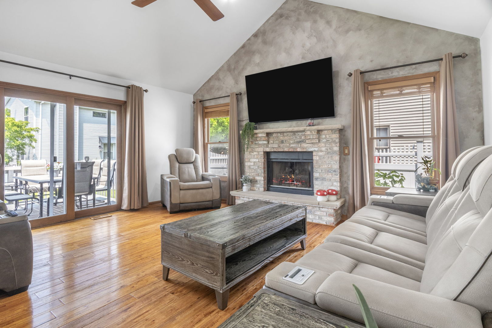 5207 Sunmeadow Drive Plainfield, IL 60586 - Photo 12 of 32 a living room with fireplace furniture and a flat screen tv