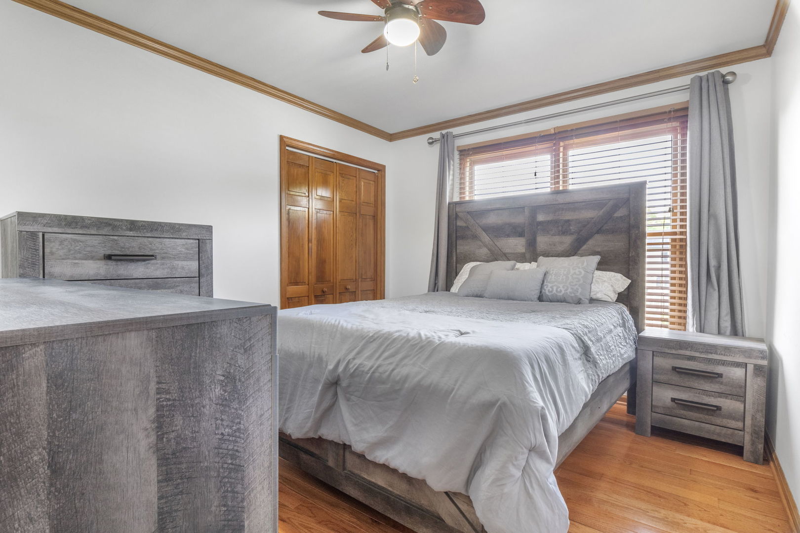 5207 Sunmeadow Drive Plainfield, IL 60586 - Photo 19 of 32 a bedroom with a bed and a chandelier