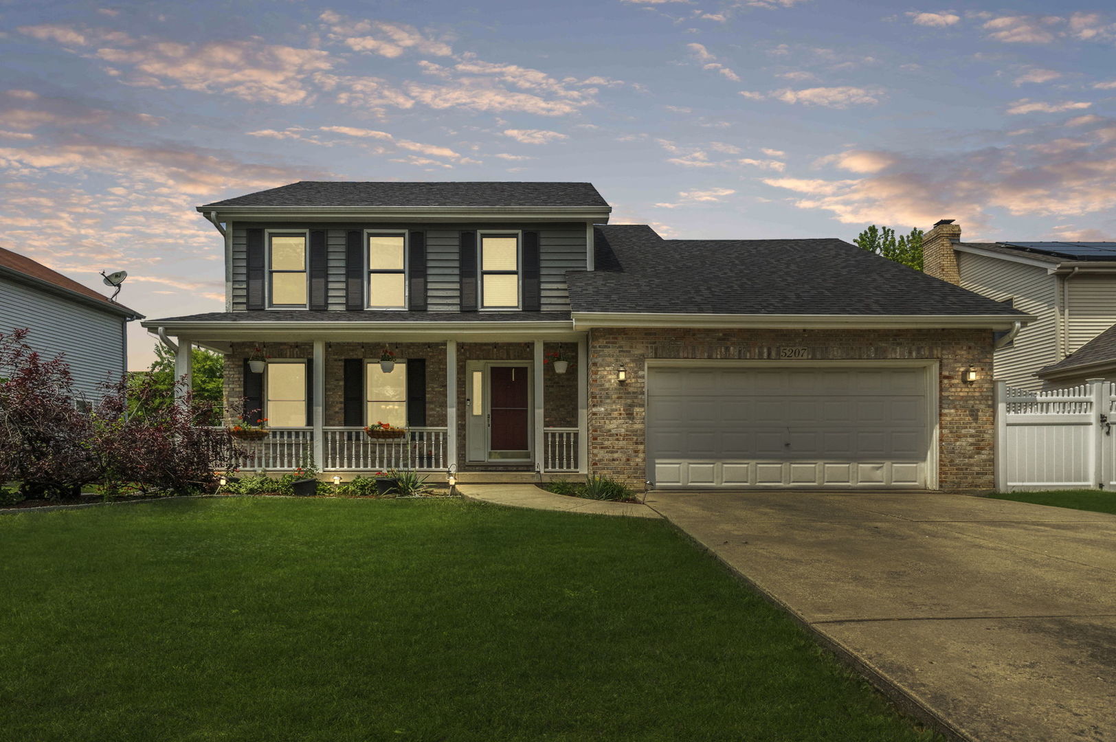 5207 Sunmeadow Drive Plainfield, IL 60586 - Photo 2 of 32 a front view of a house with a yard and garage