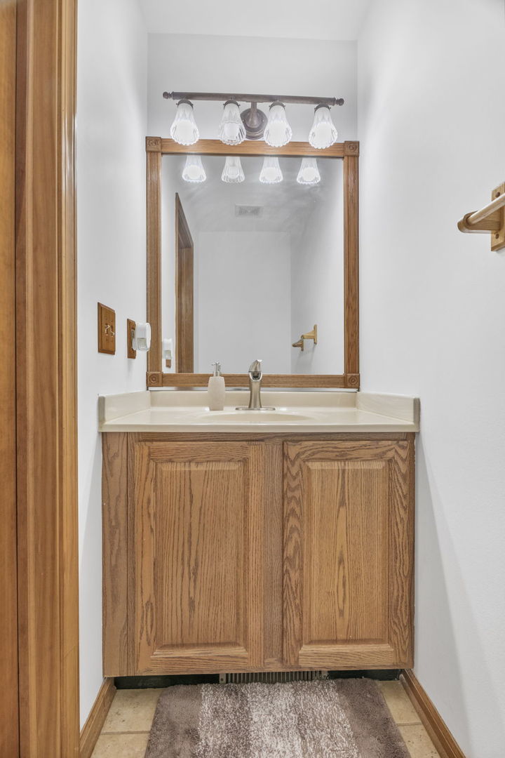 5207 Sunmeadow Drive Plainfield, IL 60586 - Photo 26 of 32 a bathroom with a sink and a mirror