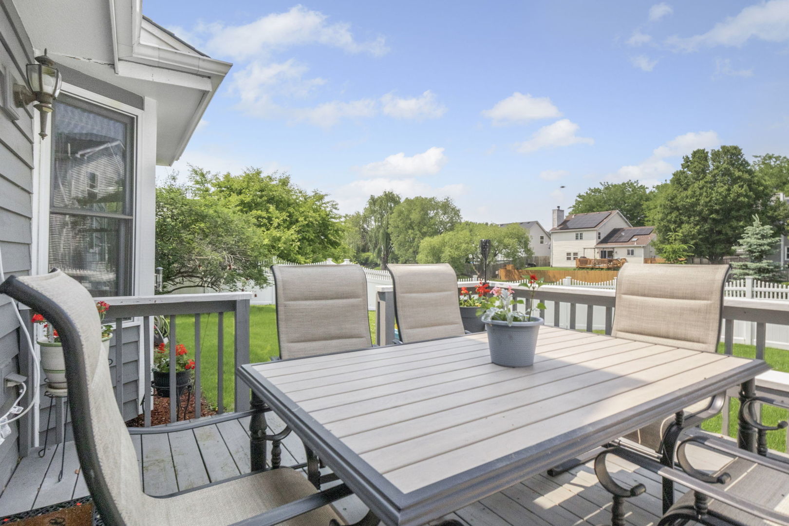5207 Sunmeadow Drive Plainfield, IL 60586 - Photo 31 of 32 a view of a dining table and chairs on the roof deck