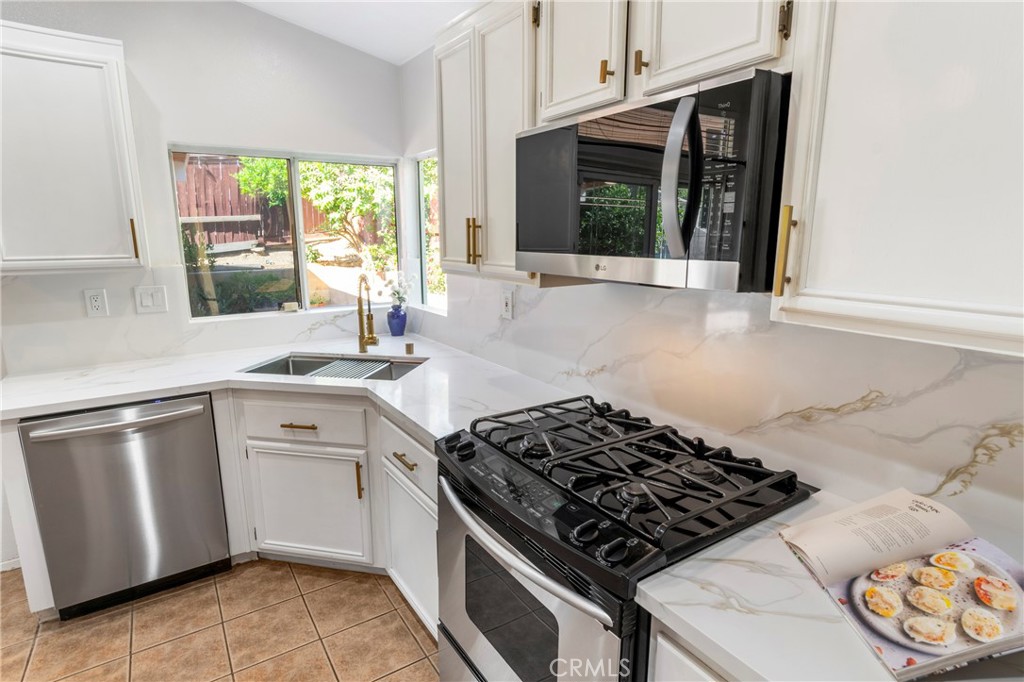 16366 West Sun Canyon Street Riverside, CA 92503 - Photo 8 of 21 a kitchen with stainless steel appliances granite countertop a stove a sink and a microwave