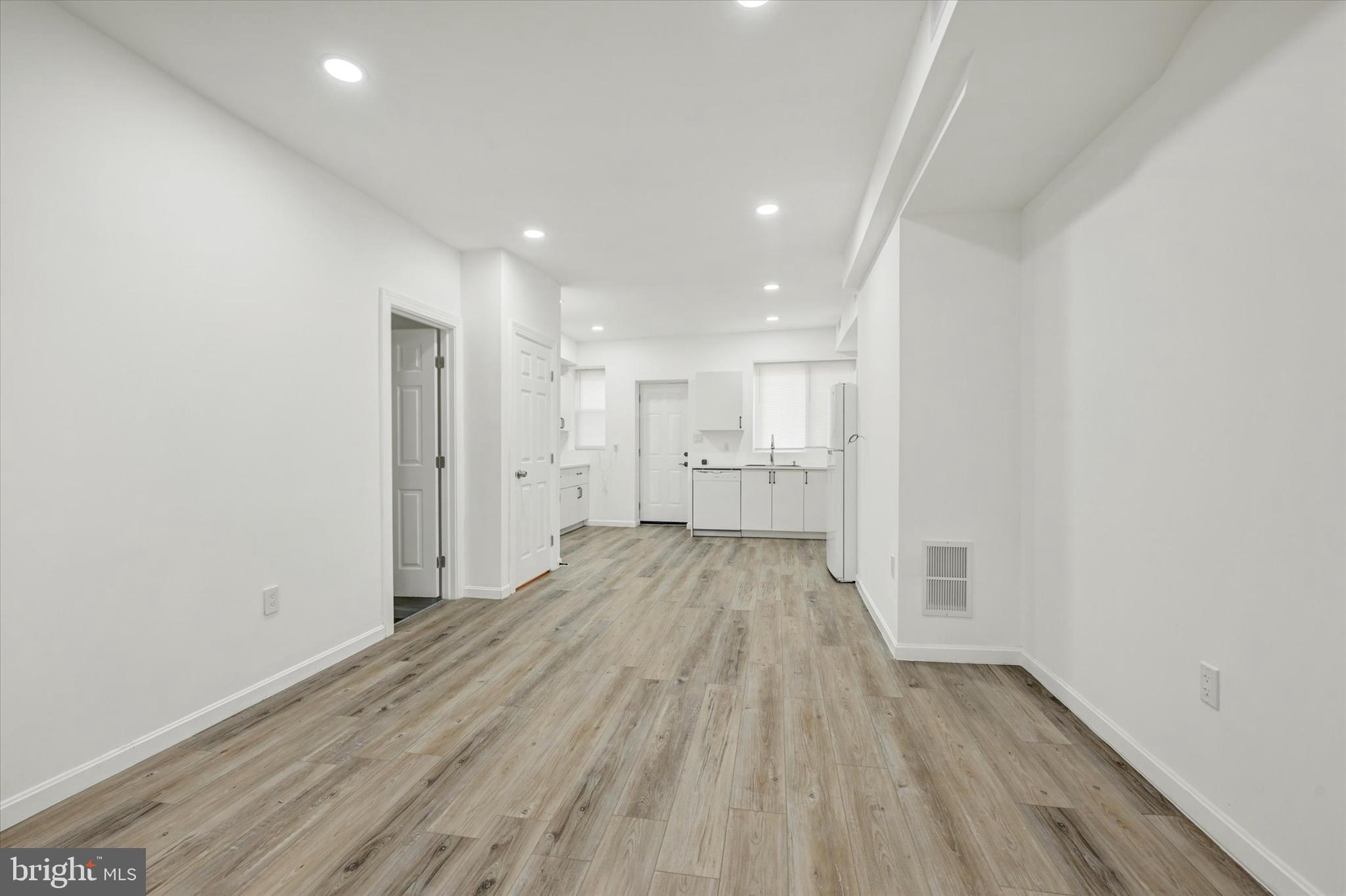 1604 Carswell Street Baltimore, MD 21218 - Photo 4 of 14 a view of empty room with wooden floor