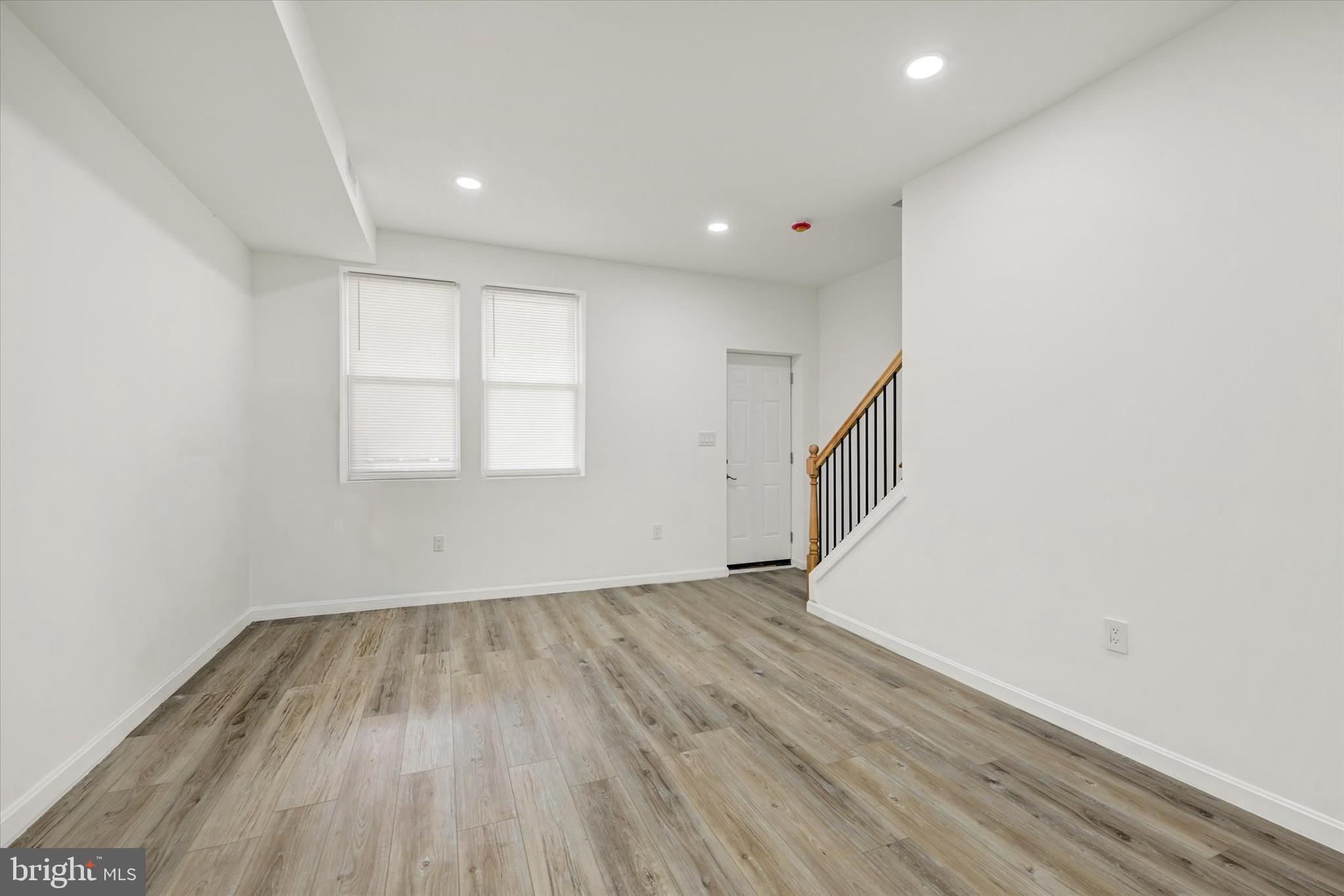 1604 Carswell Street Baltimore, MD 21218 - Photo 5 of 14 wooden floor in an empty room with a window