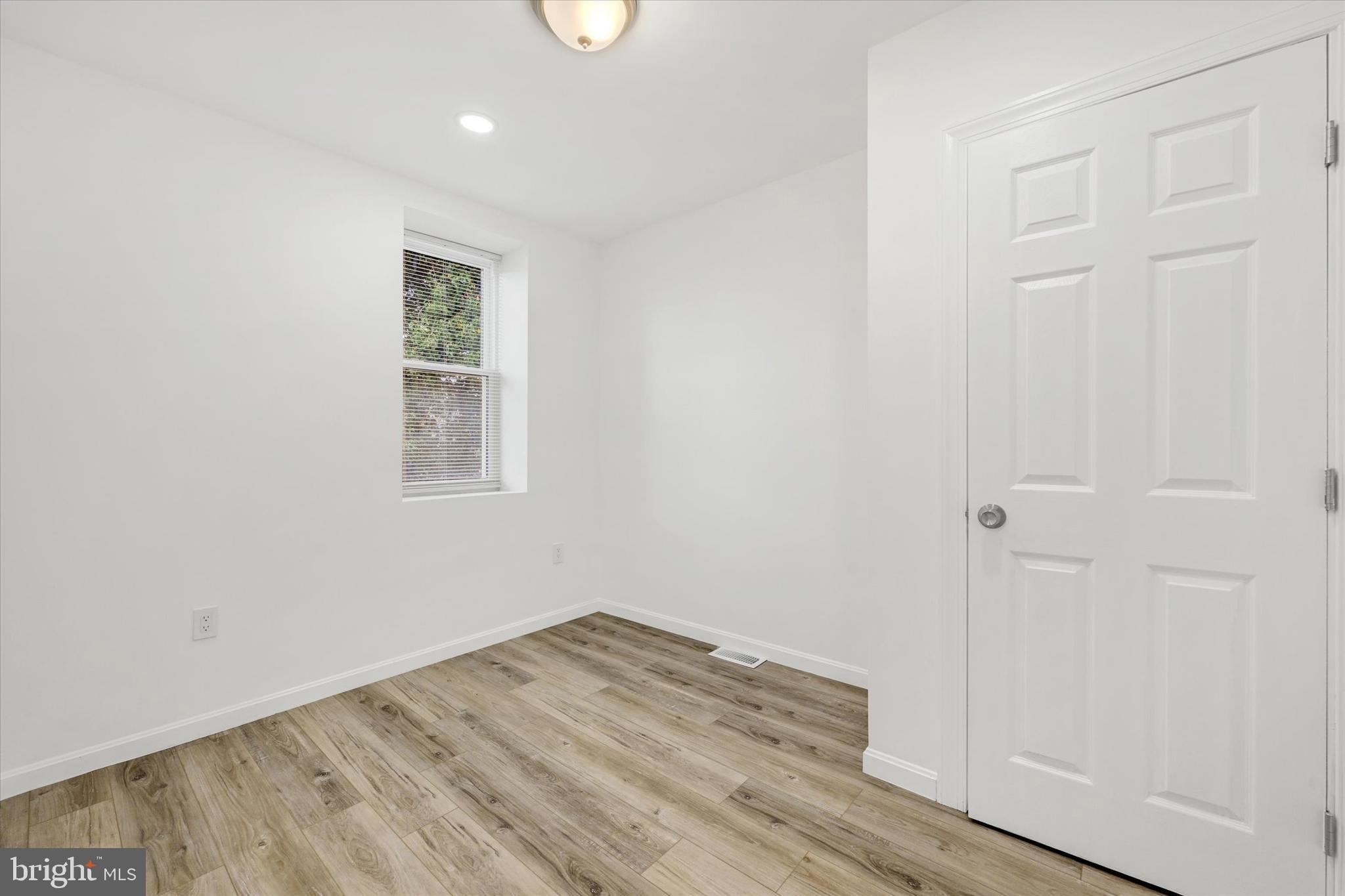 1604 Carswell Street Baltimore, MD 21218 - Photo 8 of 14 an empty room with wooden floor and closet
