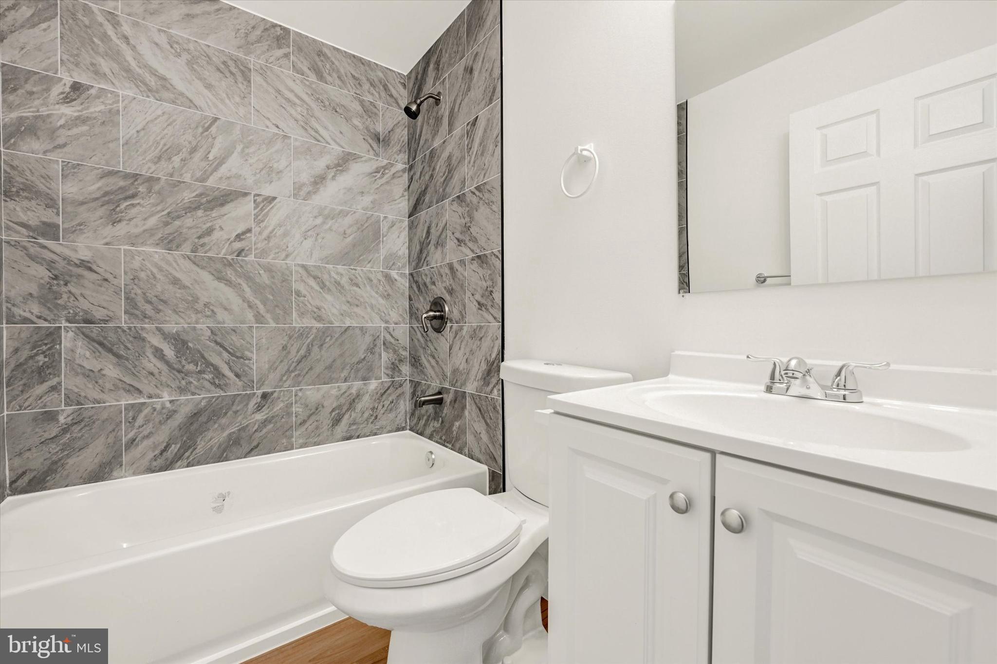 1604 Carswell Street Baltimore, MD 21218 - Photo 10 of 14 a bathroom with a sink toilet and shower