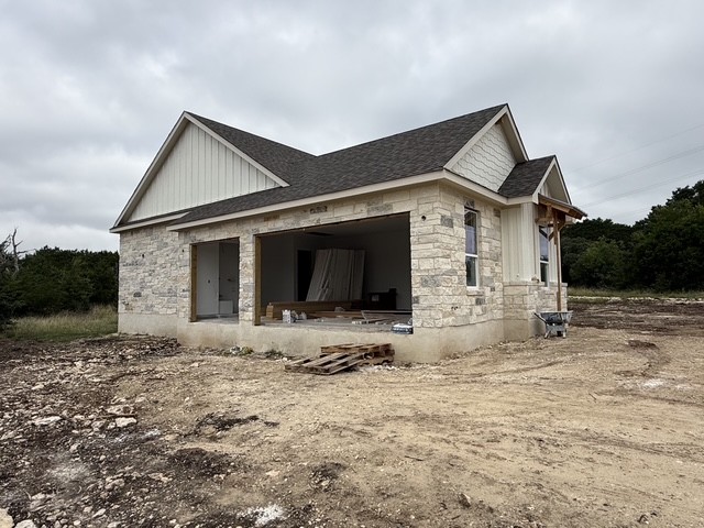 127 Riparian Elms Road Bertram, TX 78605 - Photo 21 of 22 A new construction with stone and siding exterior offers modern appeal, poised for completion.