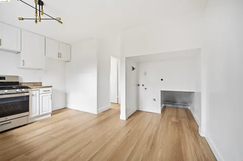 a kitchen with wooden floors and white appliances