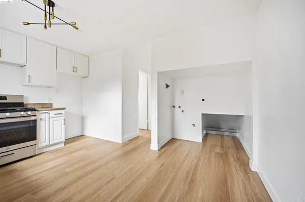 a kitchen with wooden floors and white appliances