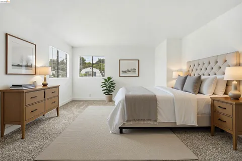 a spacious bedroom with a bed and a couch