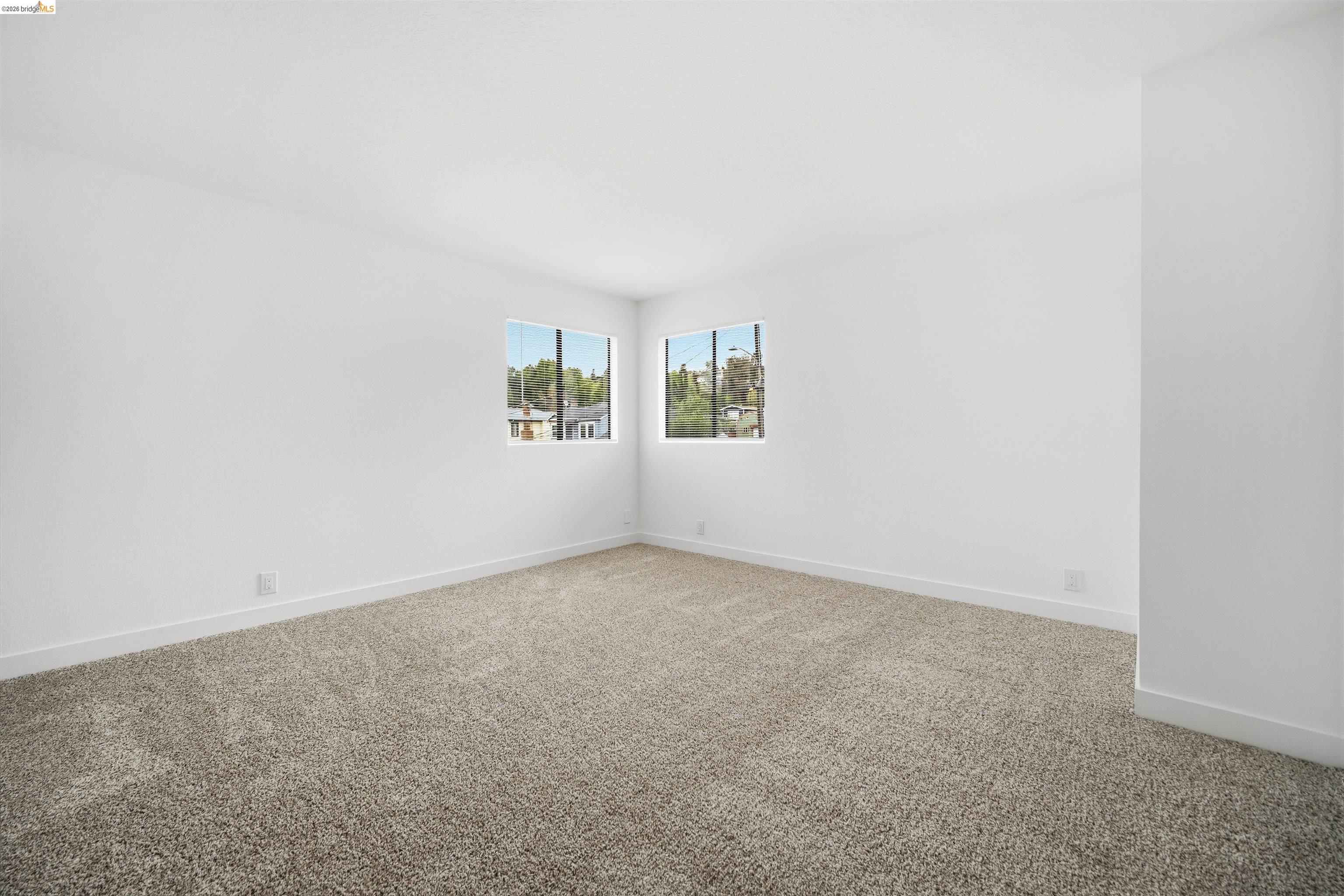 10933 Julius Street, Unit D Oakland, CA 94605 - Photo 19 of 28 Empty room with carpet and baseboards