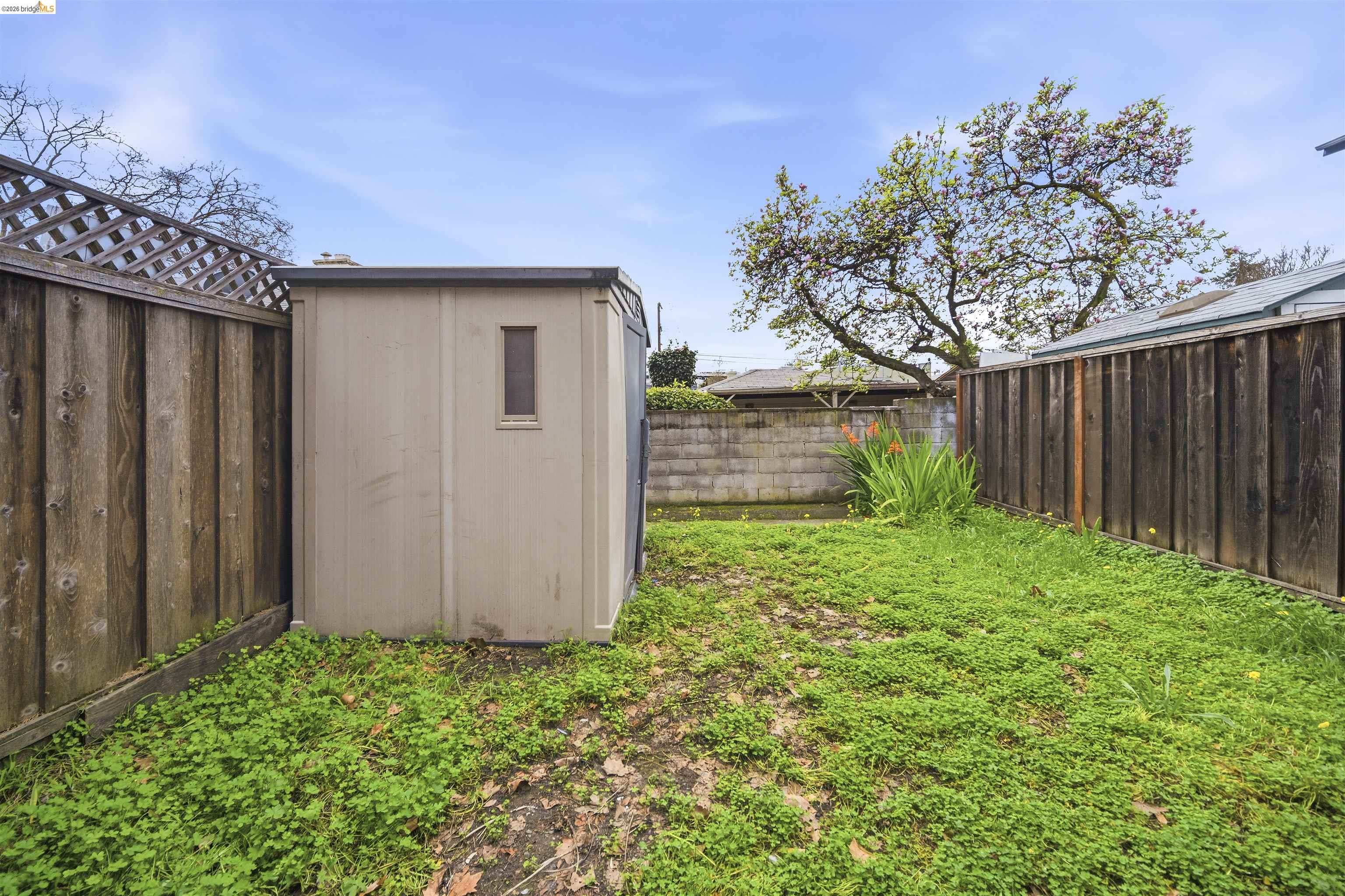 10933 Julius Street, Unit D Oakland, CA 94605 - Photo 23 of 28 Fenced backyard featuring a storage shed
