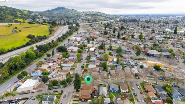 an aerial view of ocean and residential houses with outdoor space