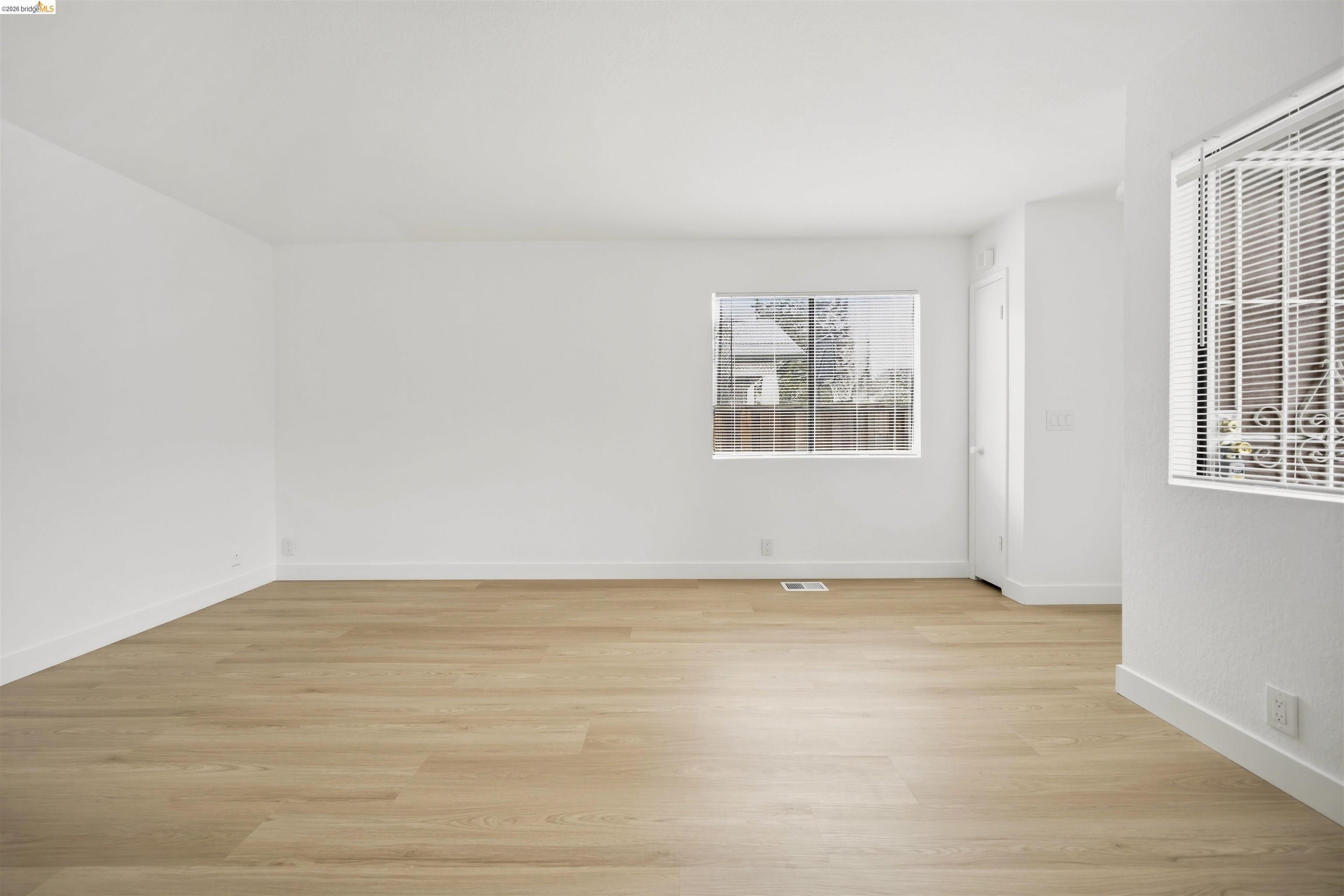 10933 Julius Street, Unit D Oakland, CA 94605 - Photo 6 of 28 Unfurnished room featuring light wood-style floors
