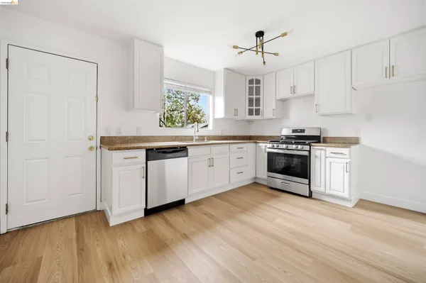 a kitchen with wooden floors and white appliances