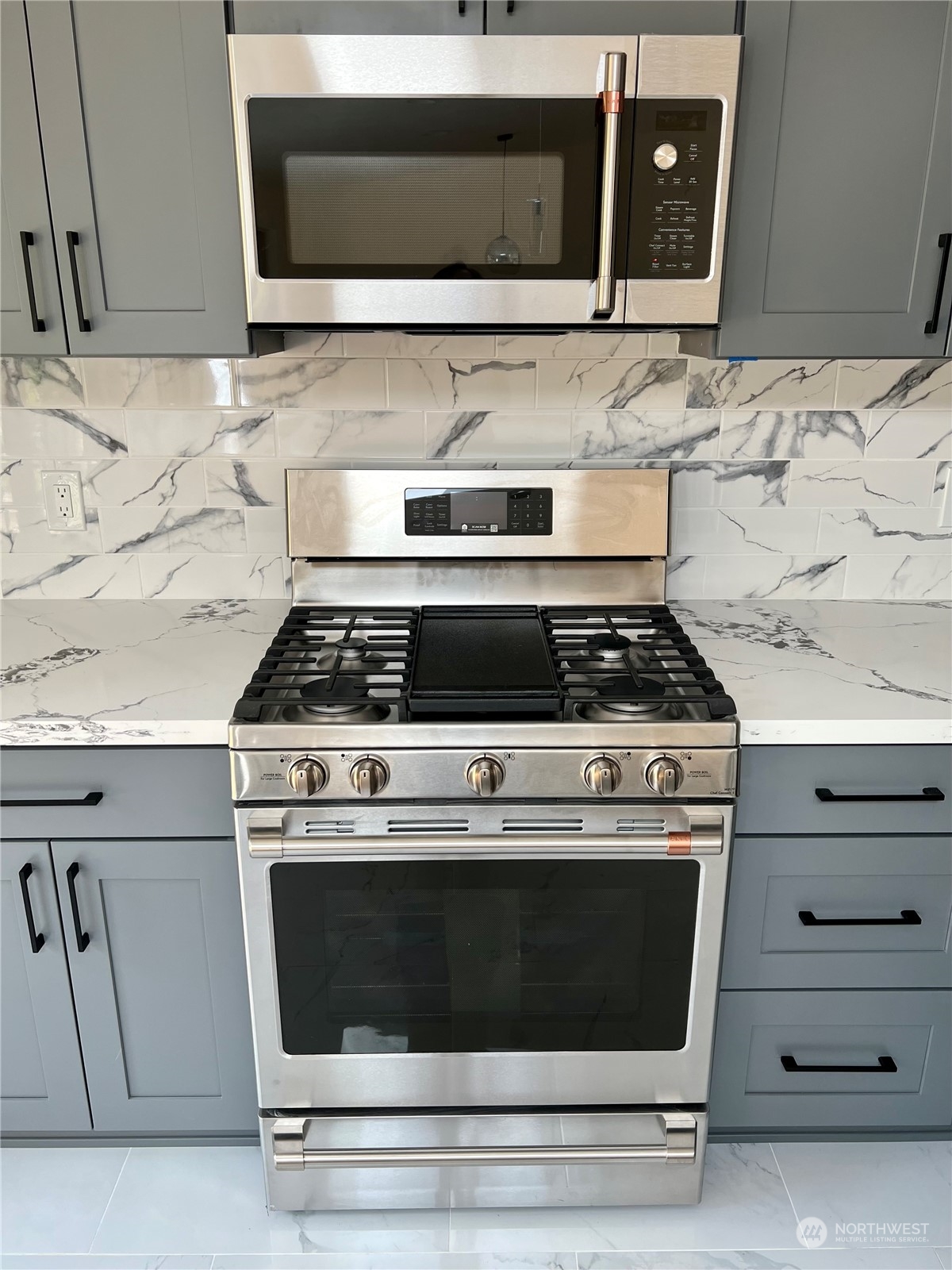 22925 49th Avenue Southeast Bothell, WA 98021 - Photo 11 of 40 a stove top oven sitting inside of a kitchen